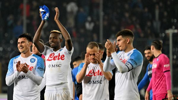 Napoli's Macedonian midfielder Eljif Elmas (L), Napoli's Nigerian forward Victor Osimhen (2nd L), and Napoli's Italian defender Giovanni Di Lorenzo (R) celebrate their 2-0 win at the end of the Italian Serie A football match between Empoli FC and SSC Napoli at the Stadio comunale Carlo Castellani stadium in Empoli on February 25, 2023. (Photo by Alberto PIZZOLI / AFP)