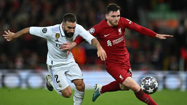 Real Madrid's Spanish defender Dani Carvajal (L) vies with Liverpool's Scottish defender Andrew Robertson during the UEFA Champions League last 16 first leg football match between Liverpool and Real Madrid at Anfield in Liverpool, north west England on February 21, 2023. (Photo by Paul ELLIS / AFP)