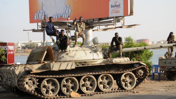 Sudanese army soldiers, loyal to army chief Abdel Fattah al-Burhan, sit atop a tank in the Red Sea city of Port Sudan, on April 20, 2023. (Photo by AFP) Sudan