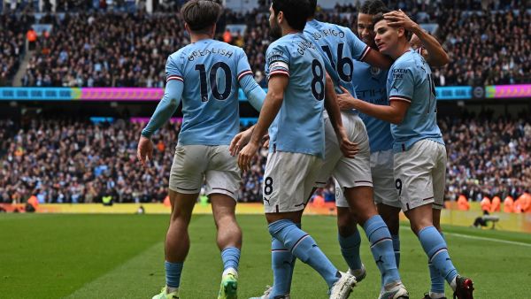 Manchester City's Argentinian striker Julian Alvarez (R) celebrates with teammates after scoring their first goal during the English Premier League football match between Manchester City and Liverpool at the Etihad Stadium in Manchester, north west England, on April 1, 2023. (Photo by Paul ELLIS / AFP)