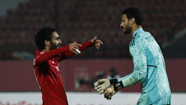 Ahly's Egyptian midfielder Hussein el-Shahat (L) celebrates with Ahly's Egyptian goalkeeper Mohamed el-Shenawy after scoring a goal during the CAF Champions League group B match between Egypt's al-Ahly and South Africa’s Mamelodi Sundowns at the al-Salam stadium in Cairo on February 25, 2023. (Photo by Khaled DESOUKI / AFP)