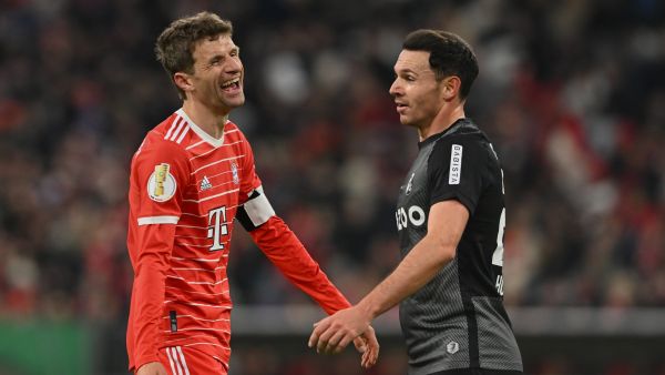 Bayern Munich's German forward Thomas Mueller (L) laughs next to Freiburg's German midfielder Nicolas Hoefler during the German Cup (DFB Pokal) quarter-final football match FC Bayern Munich v SC Freiburg in Munich southern Germany on April 4, 2023. (Photo by CHRISTOF STACHE / AFP)