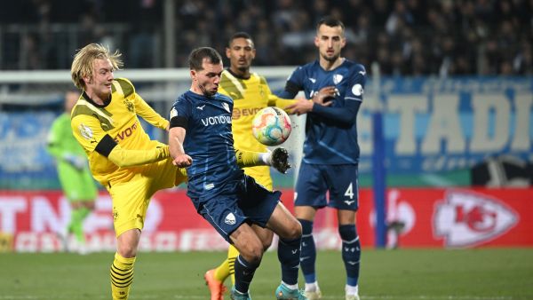 Dortmund's German midfielder Julian Brandt (L) and Bochum's Austrian midfielder Kevin Stoeger (2nd L) vie for the ball during the German Cup (DFB Pokal) football match VfL Bochum v BVB Borussia Dortmund in Bochum, western Germany on February 8, 2023. (Photo by INA FASSBENDER / AFP)