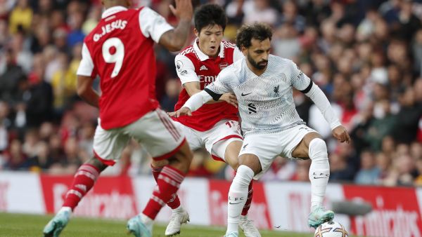 Liverpool's Egyptian striker Mohamed Salah (R) vies with Arsenal's Japanese defender Takehiro Tomiyasu (2R) during the English Premier League football match between Arsenal and Liverpool at the Emirates Stadium in London on October 9, 2022. (Photo by Ian Kington / IKIMAGES / AFP)