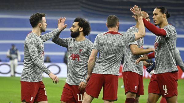 Liverpool's Egyptian forward Mohamed Salah (2L) and teammates slap hands prior to the UEFA Champions League last 16 second leg football match between Real Madrid CF and Liverpool FC at the Santiago Bernabeu stadium in Madrid on March 15, 2023. (Photo by JAVIER SORIANO / AFP)