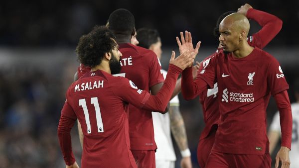 Liverpool's Egyptian striker Mohamed Salah (L) celebrates with Liverpool's Brazilian midfielder Fabinho (R) after scoring their second goal during the English Premier League football match between Leeds United and Liverpool at Elland Road in Leeds, northern England on April 17, 2023. (Photo by Oli SCARFF / AFP)