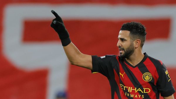 Manchester City's Algerian midfielder Riyad Mahrez celebrates scoring the opening goal during the UEFA Champions League round of 16, first-leg football match between RB Leipzig and Manchester City in Leipzig, eastern Germany on February 22, 2023. (Photo by Odd ANDERSEN / AFP)