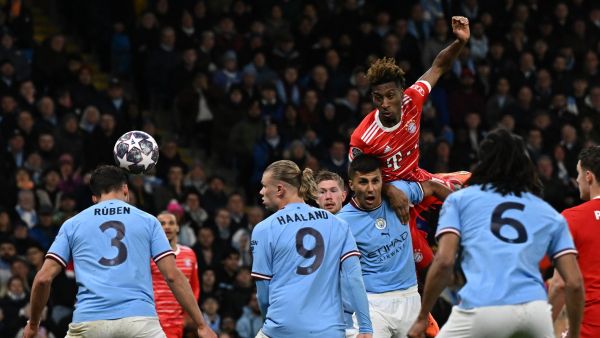 Bayern Munich's French striker Kingsley Coman (C) is unsuccessful with this header during the UEFA Champions League quarter final, first leg football match between Manchester City and Bayern Munich at the Etihad Stadium in Manchester, north-west England, on April 11, 2023. (Photo by Paul ELLIS / AFP)