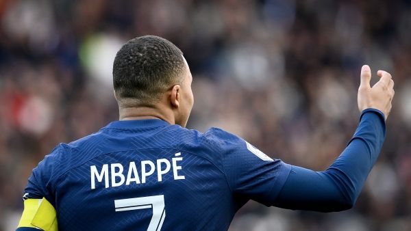 Paris Saint-Germain's French forward Kylian Mbappe wearing the captain armband enters the pitch prior to the French L1 football match between Paris Saint-Germain (PSG) and Stade Rennais FC at The Parc des Princes Stadium in Paris on March 19, 2023. (Photo by FRANCK FIFE / AFP)