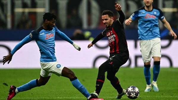 Napoli's Cameroonian midfielder Andre Zambo Anguissa (L) and AC Milan's Algerian defender Ismael Bennacer go for the ball during the UEFA Champions League quarter-finals first leg football match between AC Milan and SSC Napoli on April 12, 2023 at the San Siro stadium in Milan. (Photo by GABRIEL BOUYS / AFP)