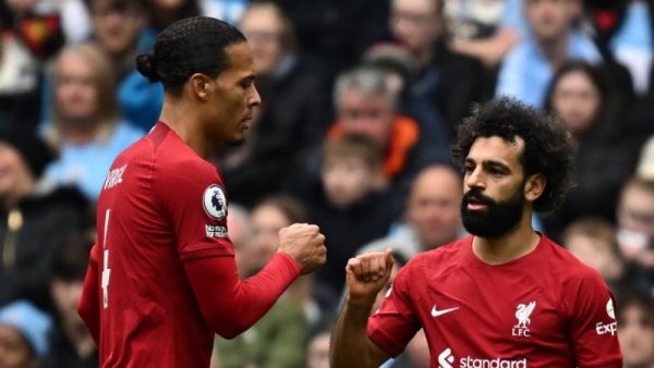 iverpool's Egyptian striker Mohamed Salah (R) celebrates with Liverpool's Dutch defender Virgil van Dijk (L) after scoring the opening goal of the English Premier League football match between Manchester City and Liverpool at the Etihad Stadium in Manchester, north west England, on April 1, 2023. (Photo by Paul ELLIS / AFP)