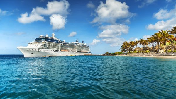 WILLEMSTAD, CURACAO - APRIL 10, 2018: View from infinity pool with beach on Cruise ship Celebrity Eclipse docked at port Willemstad.