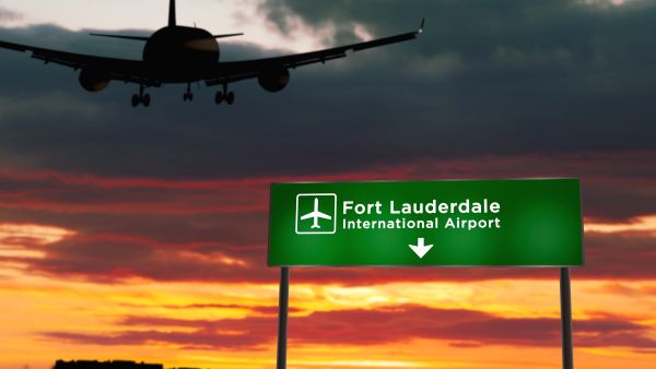 Airplanes sat at Fort Lauderdale-Hollywood International Airport Thursday after heavy rain caused the airport to shut down. Airplane flying over sign for Fort Lauderdale-Hollywood International Airport