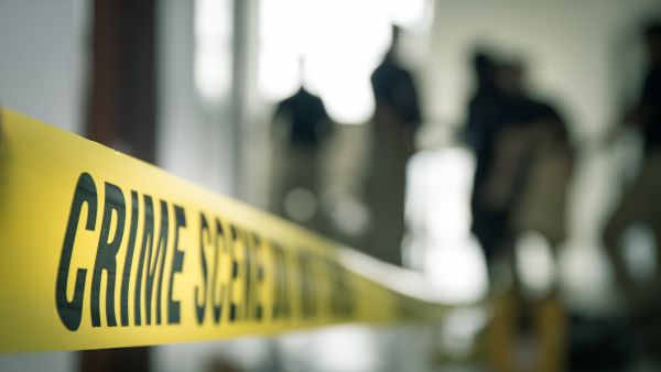 Authorities say Viktoria Nasyrova laced a slice of cheesecake with a highly potent sedative, which was found in the residue left on the empty container. crime scene tape with blurred forensic law enforcement background in cinematic tone and copy space