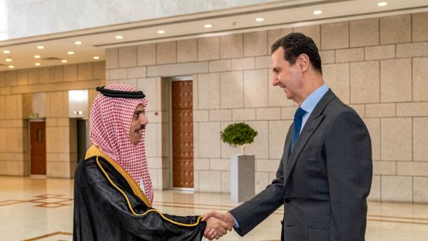 This handout picture released by the Syrian Presidency Facebook page shows Syria's President Bashar al-Assad (R) receiving Saudi Arabia's Foreign Minister Faisal bin Farhan in Damascus on April 18, 2023. (Photo by Syrian Presidency Facebook page / AFP) Arab League