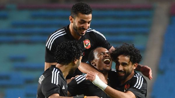 Ahly's South African forward Percy Tau (C) celebrates with teammates after scoring his team's second goal during the CAF Champions League semi-final football match between Tunisia's Esperance Sportive de Tunis and Egypt's Al-Ahly at the Hammadi Agrebi Stadium in Rades on May 12, 2023. (Photo by FETHI BELAID / AFP)