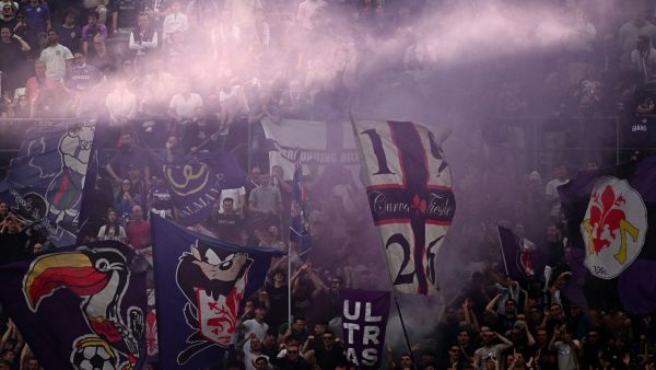 Fiorentina fans cheer during the Italian Serie A football match between Inter and Fiorentina on April 1, 2023 at the Giuseppe-Meazza (San Siro) stadium in Milan. (Photo by GABRIEL BOUYS / AFP)