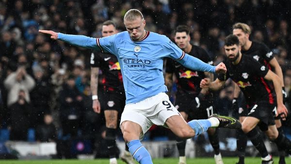 Manchester City's Norwegian striker Erling Haaland shoots from the penalty spot to score the team's  opening goal during the UEFA Champions League round of 16 second-leg football match between Manchester City and RB Leipzig at the Etihad Stadium in Manchester, north west England, on March 14, 2023. (Photo by Paul ELLIS / AFP)