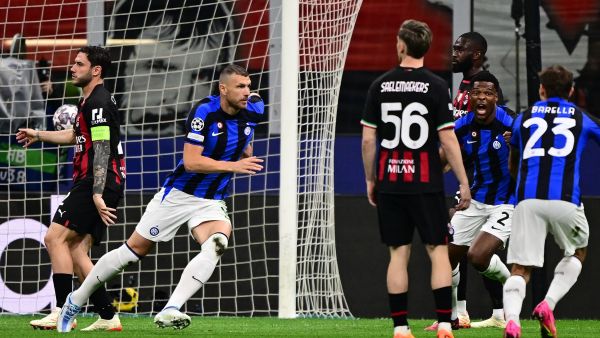 Inter Milan's Bosnian forward Edin Dzeko (2ndL) celebrates after opening the scoring during the UEFA Champions League semi-final first leg football match between AC Milan and Inter Milan, on May 10, 2023 at the San Siro stadium in Milan. (Photo by Marco BERTORELLO / AFP)