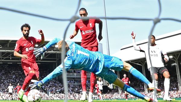 Liverpool's Egyptian striker Mohamed Salah (L) shoots to score their second goal during the English Premier League football match between Fulham and Liverpool at Craven Cottage in London on August 6, 2022. (Photo by JUSTIN TALLIS / AFP)
