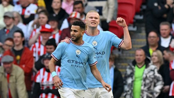 Manchester City's Algerian midfielder Riyad Mahrez (L) celebrates scoring the opening goal with Manchester City's Norwegian striker Erling Haaland during the English FA Cup semi-final football match between Manchester City and Sheffield United at Wembley Stadium in north west London on April 22, 2023. (Photo by Glyn KIRK / AFP)