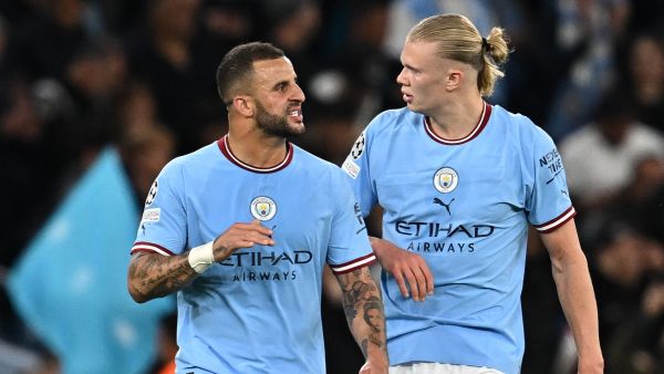 Manchester City's English defender Kyle Walker (L) talks with Manchester City's Norwegian striker Erling Haaland during the UEFA Champions League second leg semi-final football match between Manchester City and Real Madrid at the Etihad Stadium in Manchester, north west England, on May 17, 2023. (Photo by Paul ELLIS / AFP)