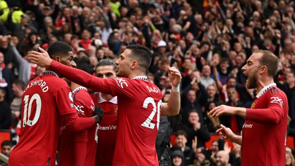Manchester United's Portuguese midfielder Bruno Fernandes celebrates with teammates after scoring his team first goal during the English Premier League football match between Manchester United and Aston Villa at Old Trafford in Manchester, north west England, on April 30, 2023. (Photo by Oli SCARFF / AFP)