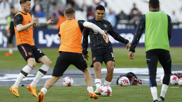 Manchester United's Brazilian midfielder Casemiro (C) warms up prior to the English Premier League football match between West Ham United and Manchester United at the London Stadium, in London on May 7, 2023. (Photo by Ian Kington / AFP)