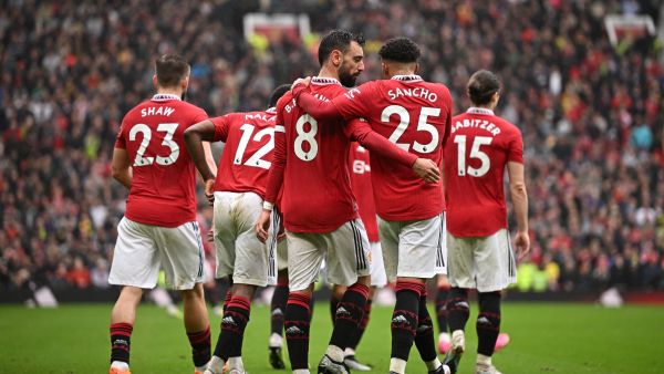Manchester United's Portuguese midfielder Bruno Fernandes celebrates with Manchester United's English striker Jadon Sancho after scoring his team first goal during the English Premier League football match between Manchester United and Aston Villa at Old Trafford in Manchester, north west England, on April 30, 2023. (Photo by Oli SCARFF / AFP) 