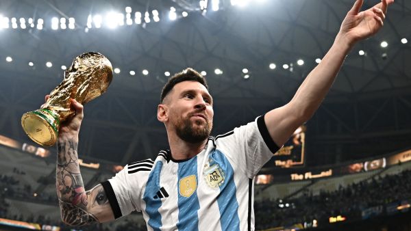 Argentina's captain and forward #10 Lionel Messi, his wife Antonela Roccuzzo and sons Thiago (C) and Ciro pose with the FIFA World Cup Trophy after Argentina won the Qatar 2022 World Cup final football match between Argentina and France at Lusail Stadium in Lusail, north of Doha on December 18, 2022. (Photo by Anne-Christine POUJOULAT / AFP)