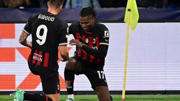 AC Milan's French forward Olivier Giroud (L) celebrates with AC Milan's Portuguese forward Rafael Leao after opening the scoring during the UEFA Champions League quarter-finals second leg football match between SSC Napoli and AC Milan on April 18, 2023 at the Diego-Maradona stadium in Naples. (Photo by Alberto PIZZOLI / AFP)