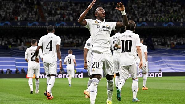 Real Madrid's Brazilian forward Vinicius Junior celebrates with teammates scoring his team's first goal during the UEFA Champions League semi-final first leg football match between Real Madrid CF and Manchester City at the Santiago Bernabeu stadium in Madrid on May 9, 2023. (Photo by JAVIER SORIANO / AFP)