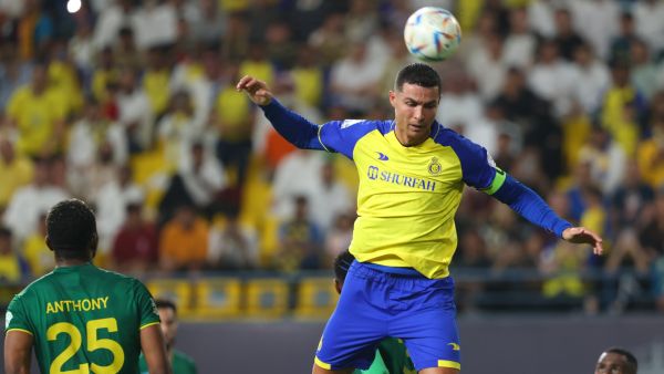 Nassr's Portuguese forward Cristiano Ronaldo jumps for a header while marked by Khaleej players during the Saudi Pro League football match between Al-Nassr and Al-Khaleej at the al-Awwal Park Stadium in the Saudi capital Riyadh on May 8, 2023. (Photo by Fayez NURELDINE / AFP)