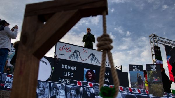 An Iranian women, life, freedom protest held in the United States. (Shutterstock) burning Quran