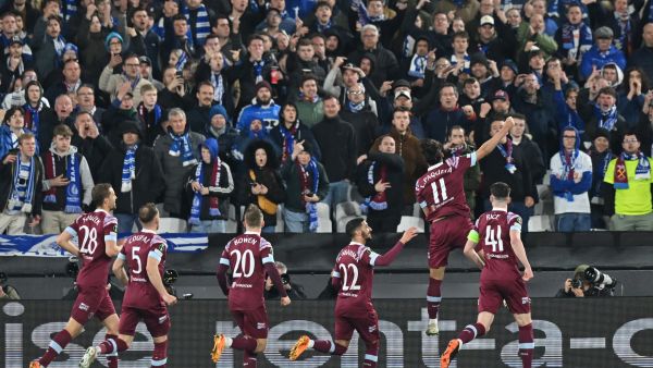 West Ham United's Brazilian midfielder Lucas Paqueta (2R) celebrates in front of the Gent fans after scoring their second goal from the penalty spot during the UEFA Europa Conference League second-leg quarter final football match between West Ham United and Gent at the London Stadium in east London on April 20, 2023. (Photo by Glyn KIRK / AFP)