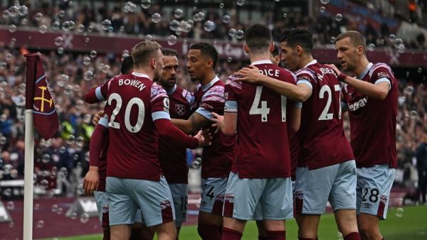 West Ham United's Algerian midfielder Said Benrahma celebrates with teammates after scoring their first goal from the penalty spot during the English Premier League football match between West Ham United and Aston Villa at the London Stadium, in London on March 12, 2023. (Photo by Ben Stansall / AFP)