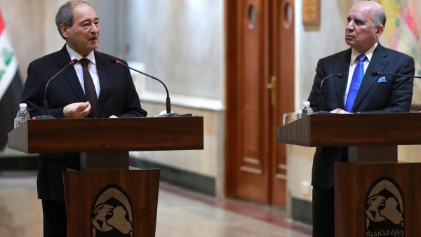 Iraqi Foreign Minister Fuad Hussein (R) and his Syrian counterpart Faisal Mekdad hold a press conference in Baghdad on June 4, 2023. (Photo by AHMAD AL-RUBAYE / AFP) Faisal Mekdad and Fuad Hussein