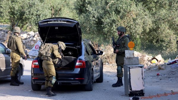 Israeli soldiers inspect a car at a checkpoint at the entrance of the Palestinian village of Orif, south of Nablus in the northern West Bank, on June 22, 2023, following an incursion by Israeli forces into the village. (Photo by Jaafar ASHTIYEH / AFP) Israeli Army
