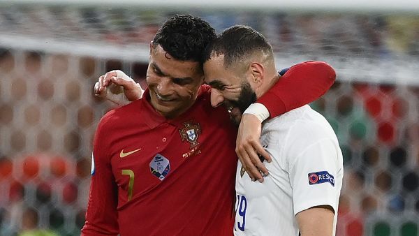 Portugal's forward Cristiano Ronaldo and France's forward Karim Benzema walk together off the pitch in half-time of the UEFA EURO 2020 Group F football match between Portugal and France at Puskas Arena in Budapest on June 23, 2021. / AFP / POOL / FRANCK FIFE