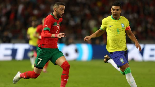 Morocco's midfielder Hakim Ziyech is marked by Brazil's midfielder Casemiro (R) during a friendly football match between Morocco and Brazil at the Ibn Batouta Stadium in Tangier on March 26, 2023. (Photo by Fadel Senna / AFP)