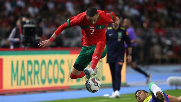 Brazil's midfielder Casemiro (R) tackles Morocco's midfielder Hakim Ziyech during a friendly football match between Morocco and Brazil at the Ibn Batouta Stadium in Tangier on March 26, 2023. (Photo by Fadel Senna / AFP)
