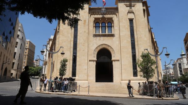 Journalists gather outside the parliament building during the 12th session to elect a new president in the capital Beirut's downtown district on June 14, 2023.  (Photo by ANWAR AMRO / AFP) Beirut