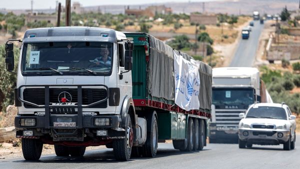 Trucks move in a United Nations aid convoy en route to Syria's rebel-held northwestern city of Idlib on June 23, 2023. (Photo by OMAR HAJ KADOUR / AFP) Syria