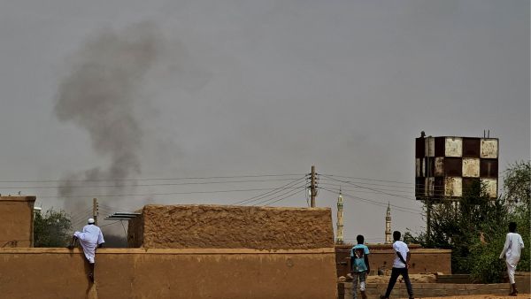 People flee as smoke billows on the first day of the Eid al-Adha Muslim holiday in Wad Hamid, about 100 kilometres north of Sudan's capital. (Photo by AFP) Sudan