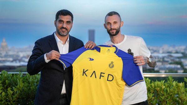This handout picture released by Saudi Arabia's al-Nassr football club on July 3, 2023 shows Nassr's new Croatian midfielder Marcelo Brozovic (R) with the club's Executive President Ahmed al-Ghamdi after signing with them in Paris. (Photo by Al Nassr Football Club / AFP)