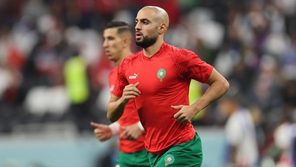 Morocco's midfielder #04 Sofyan Amrabat arrives for warm ups ahead of the Qatar 2022 World Cup semi-final football match between France and Morocco at the Al-Bayt Stadium in Al Khor, north of Doha on December 14, 2022. (Photo by KARIM JAAFAR / AFP)