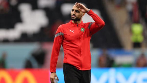 Morocco's midfielder #04 Sofyan Amrabat greets fans ahead of the Qatar 2022 World Cup semi-final football match between France and Morocco at the Al-Bayt Stadium in Al Khor, north of Doha on December 14, 2022. (Photo by KARIM JAAFAR / AFP)