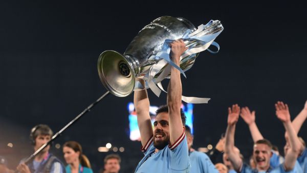 Manchester City's Portuguese midfielder #20 Bernardo Silva celebrates with the European Cup trophy after winning the UEFA Champions League final football match between Inter Milan and Manchester City at the Ataturk Olympic Stadium in Istanbul, on June 10, 2023. (Photo by FRANCK FIFE / AFP)