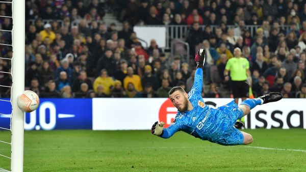 Manchester United's Spanish goalkeeper David de Gea dives for the ball during the UEFA Europa League round of 32 first-leg football match between FC Barcelona and Manchester United at the Camp Nou stadium in Barcelona, on February 16, 2023. (Photo by Pau BARRENA / AFP)