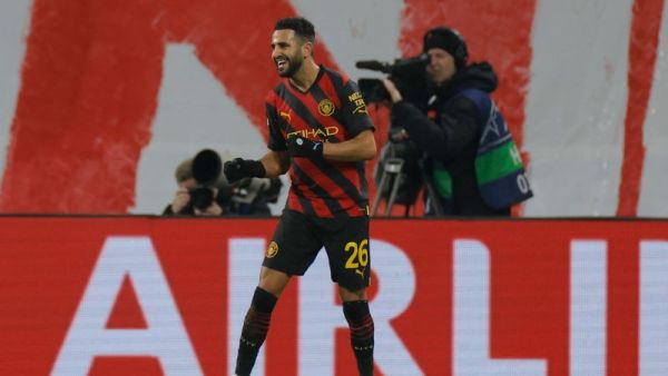 Manchester City's Algerian midfielder Riyad Mahrez celebrates scoring the opening goal during the UEFA Champions League round of 16, first-leg football match between RB Leipzig and Manchester City in Leipzig, eastern Germany on February 22, 2023. (Photo by Odd ANDERSEN / AFP)